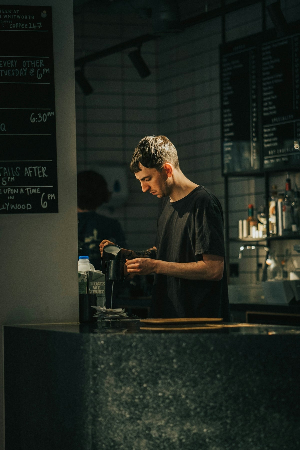 a man standing at a counter in a restaurant