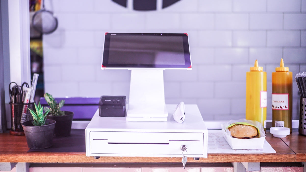 black ipad on white wooden table