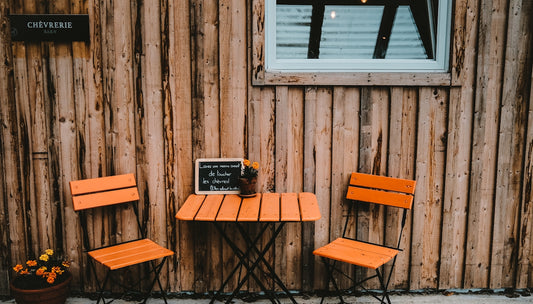 black laptop computer on brown wooden table