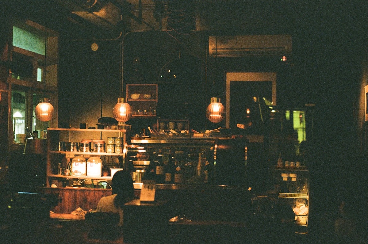 a dimly lit room with a counter and shelves