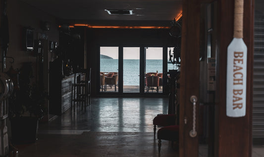 a hallway leading to a beach side restaurant