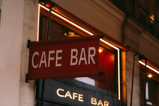 a red sign hanging from the side of a building