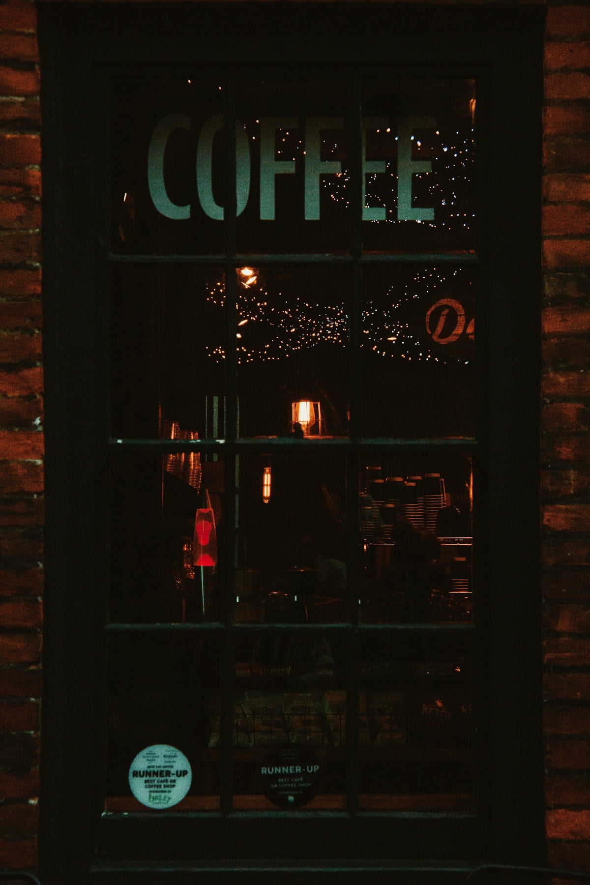 a window with a sign that reads coffee on it