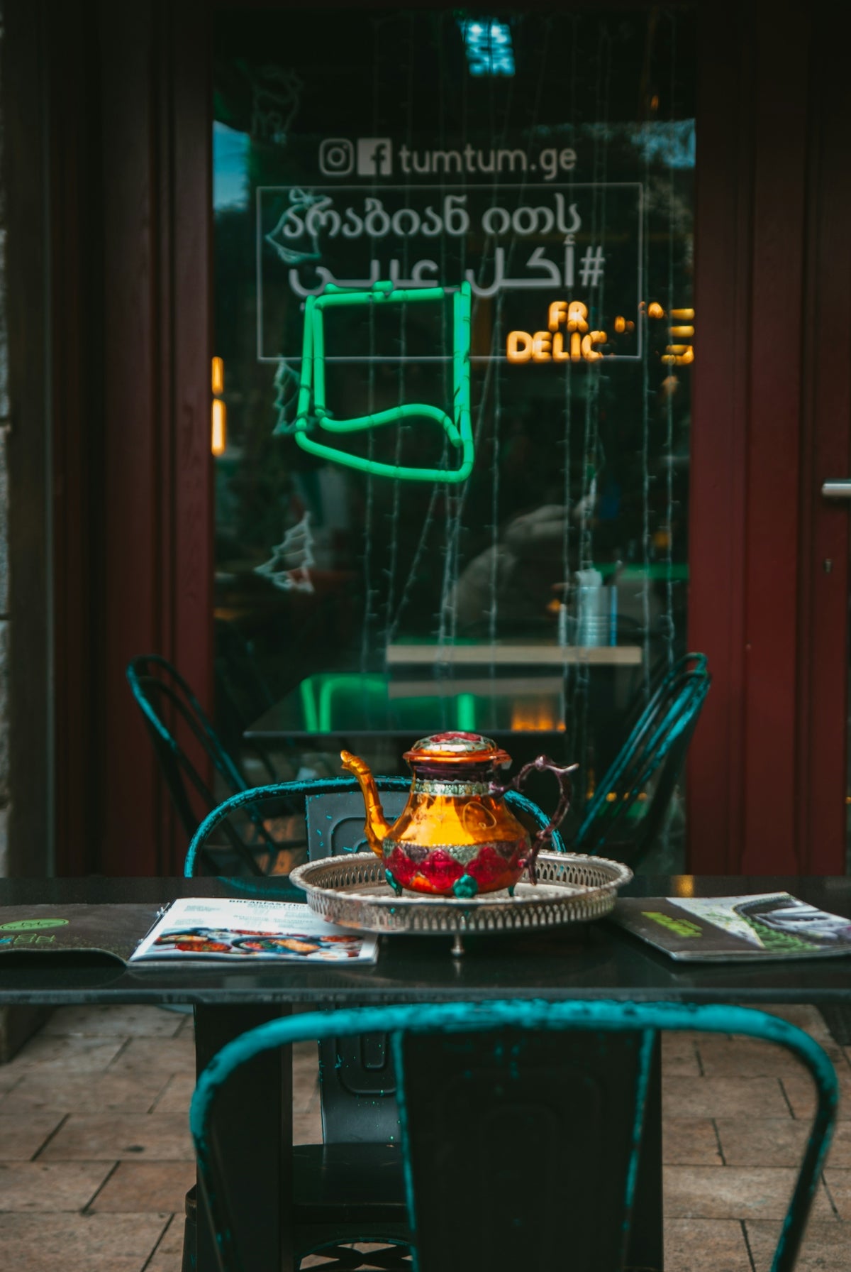 a tea pot sitting on top of a metal table