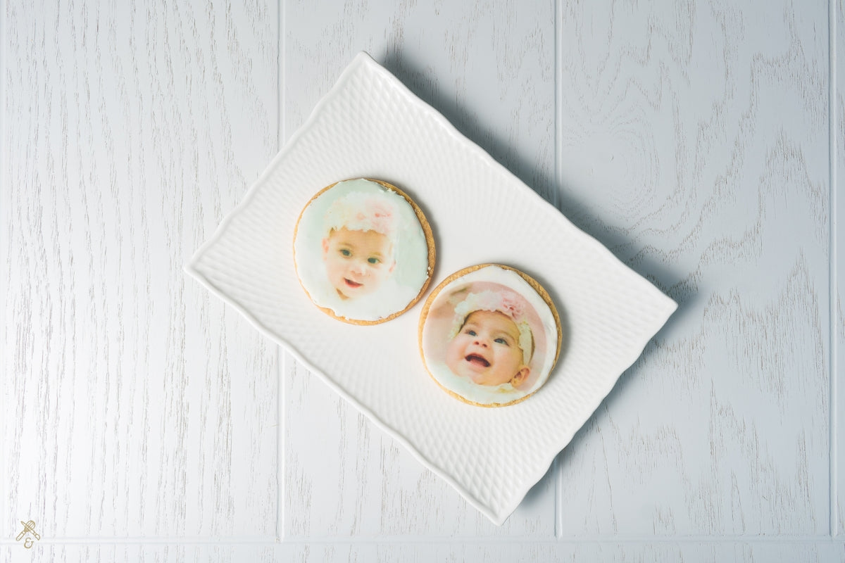 Two cookies with a picture of a baby on them