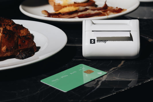 A table topped with plates of food and a credit card