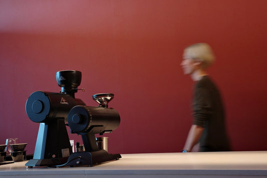 Coffee grinders are set up with a person walking.