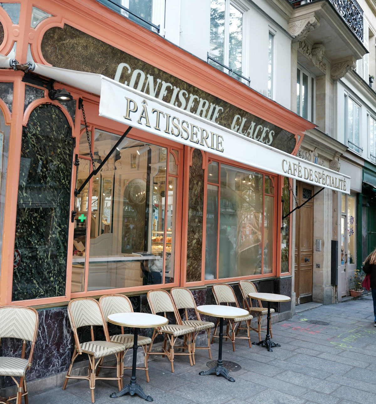 Parisian cafe with outdoor seating and awning